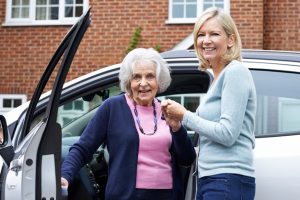 Female Giving Senior Woman A Lift In Car