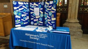 Information stall with blue tablecloth and messages on display